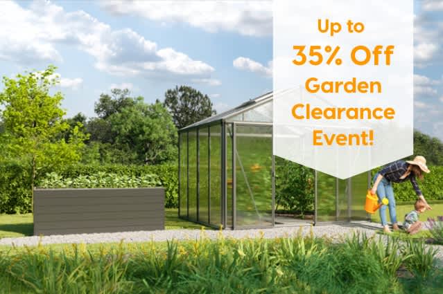 Up to 35% off Garden Clearance Event. Modern greenhouse beside a raised garden bed in a landscaped garden