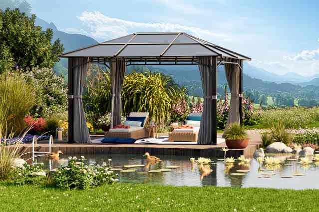 garden gazebo with stylish curtains in hedged backyard with trees