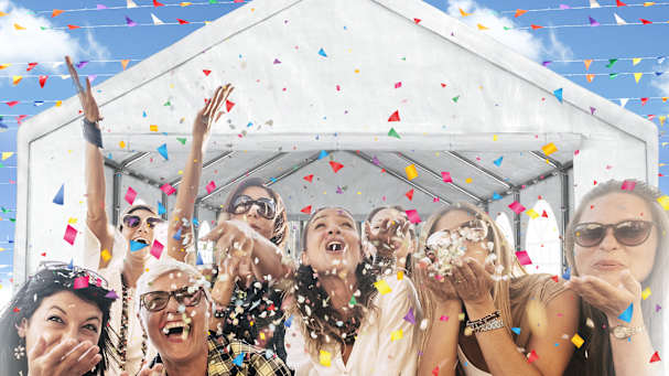 Crowd at an outdoor festival with black pop-up canopy tents used as vendor booths