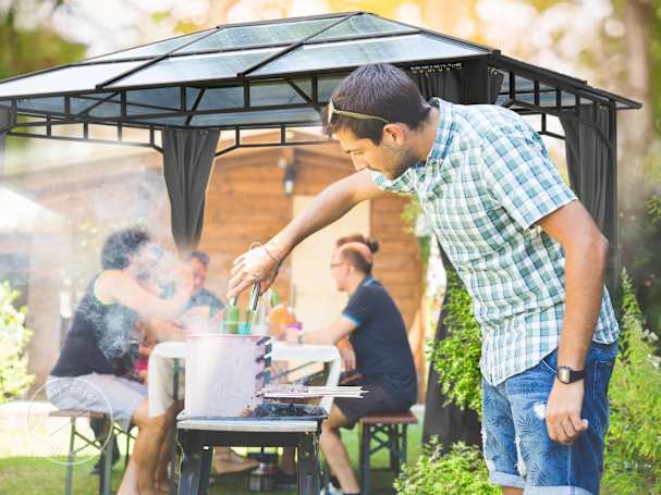 bbq near a hardtop gazebo
