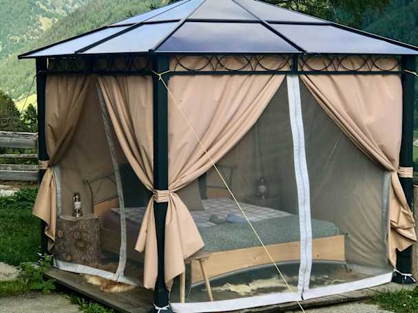 mosquito net and curtains on garden gazebo